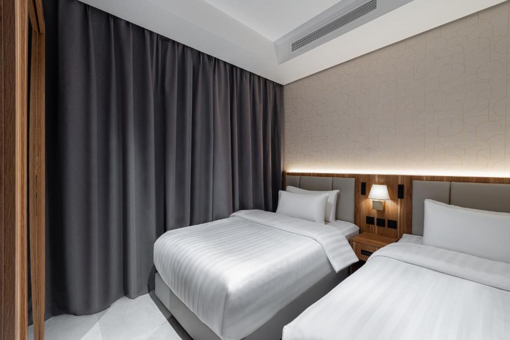 Postel nebo postele na pokoji v ubytování لفيت للشقق الفندقية المخدومة Lafait Hotel Serviced Apartments
