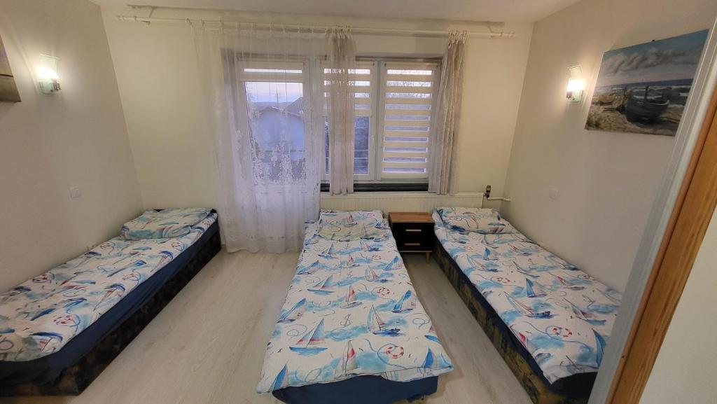 Posteľ alebo postele v izbe v ubytovaní Rozalia