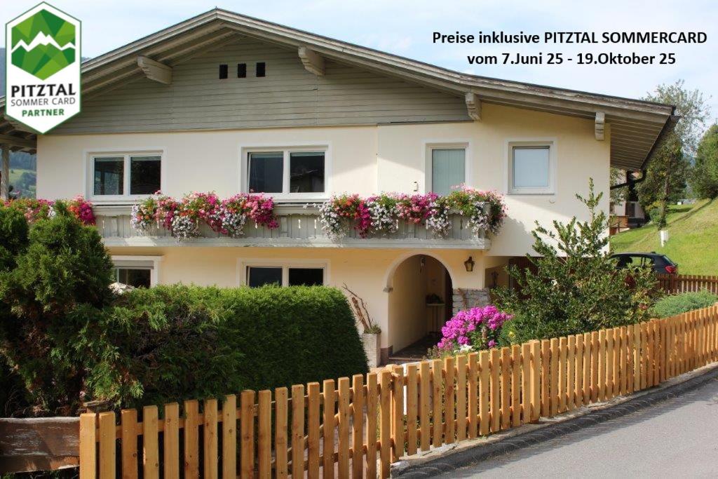 a house with a fence in front of it at Ferienwohnung Stuibenfall in Jerzens