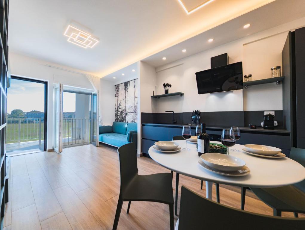 a dining room and living room with a table and chairs at Appartamenti Pamar in Civitanova Marche