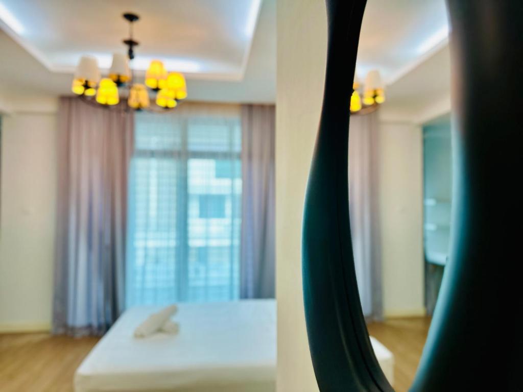 a room with a bed and a mirror at Exclusive Luxury 2MIN Walk to Beach & Night Market in Batu Ferringhi