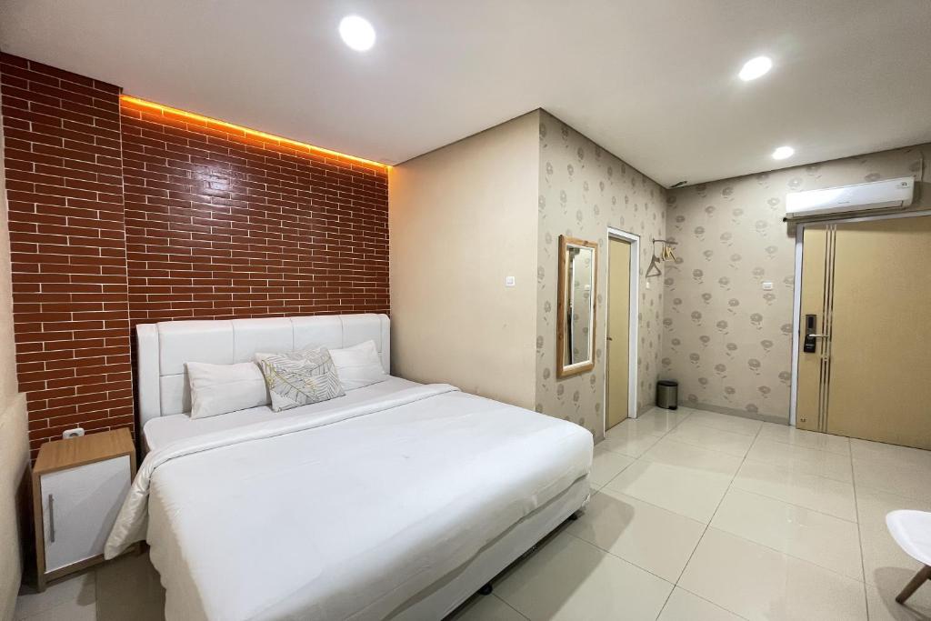 Postel nebo postele na pokoji v ubytování Hotel Lengkong 2