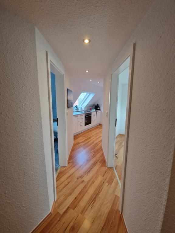 an empty hallway of a house with a kitchen at Ferienwohnungen Dümmersee - Haus Dümmerland - Wohnung 4 in Hüde