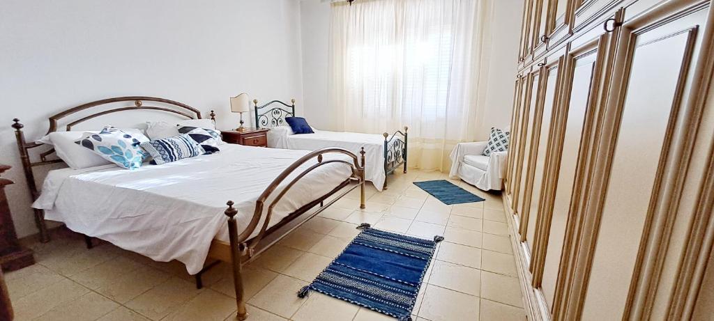 a bedroom with a bed and a chair in it at Casa Verdi Telti in Telti