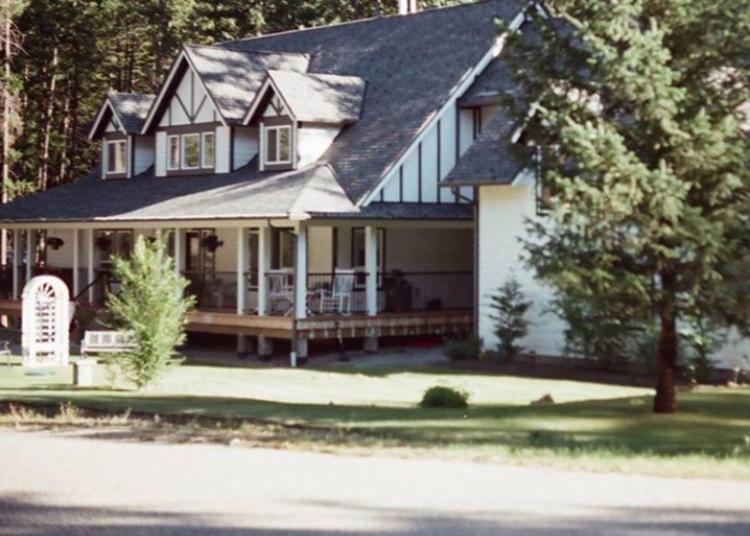 a large white house with a porch and a yard at Country Dream in Fintry