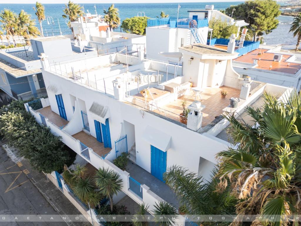 an aerial view of a white building with blue doors at Suite Giò in Savelletri di Fasano