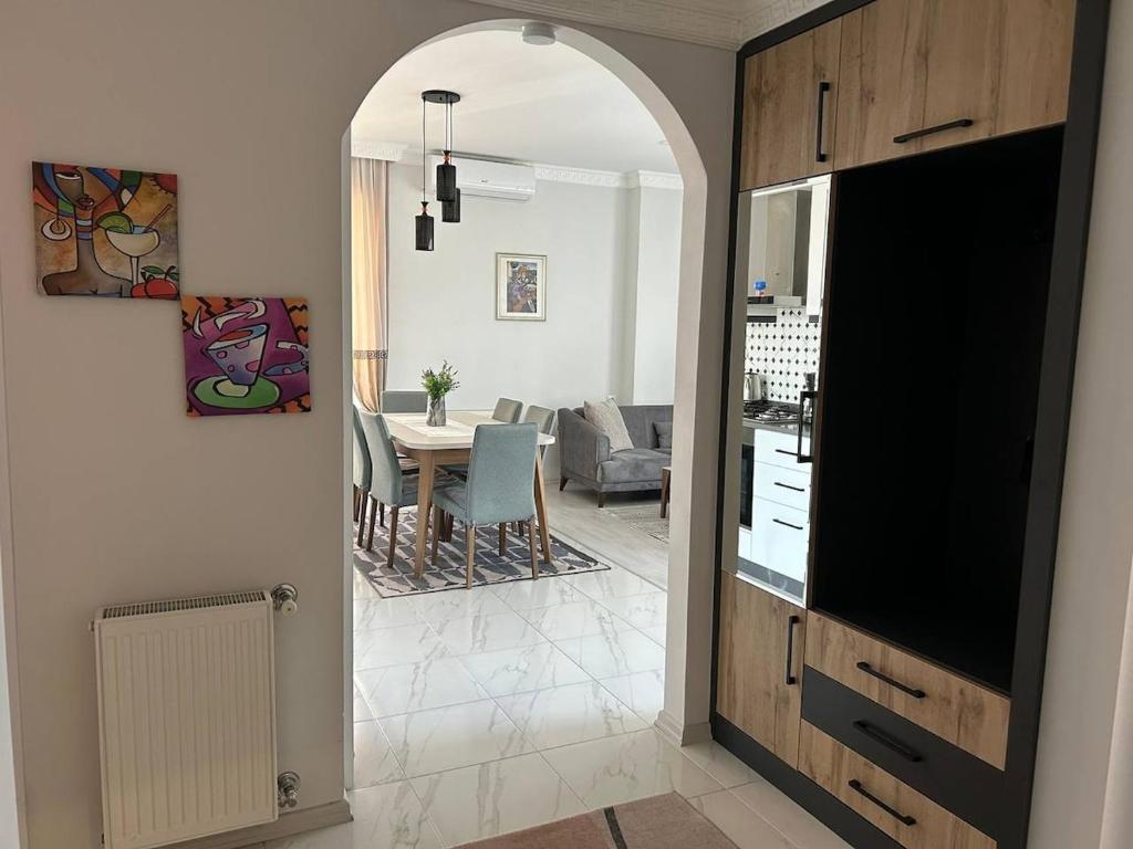 a living room with a kitchen and a dining room at Your home in the heart of Batumi, sea in 8th minute in Batumi