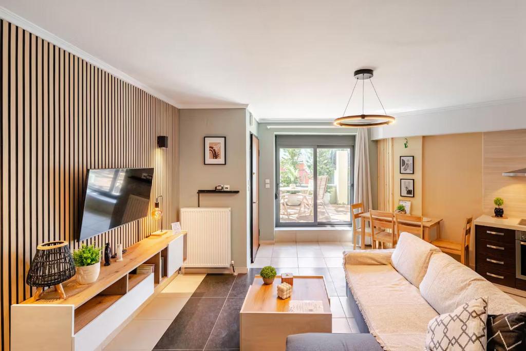 a living room with a couch and a tv at Fab Maisonette 100m2 - Private courtyard - JK 7towers -Old City Center in Thessaloniki