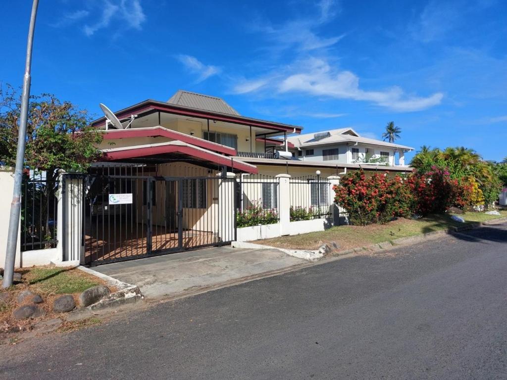 a house with a gate on the side of the street at Newtown Beach Bed and Bath in Nadi