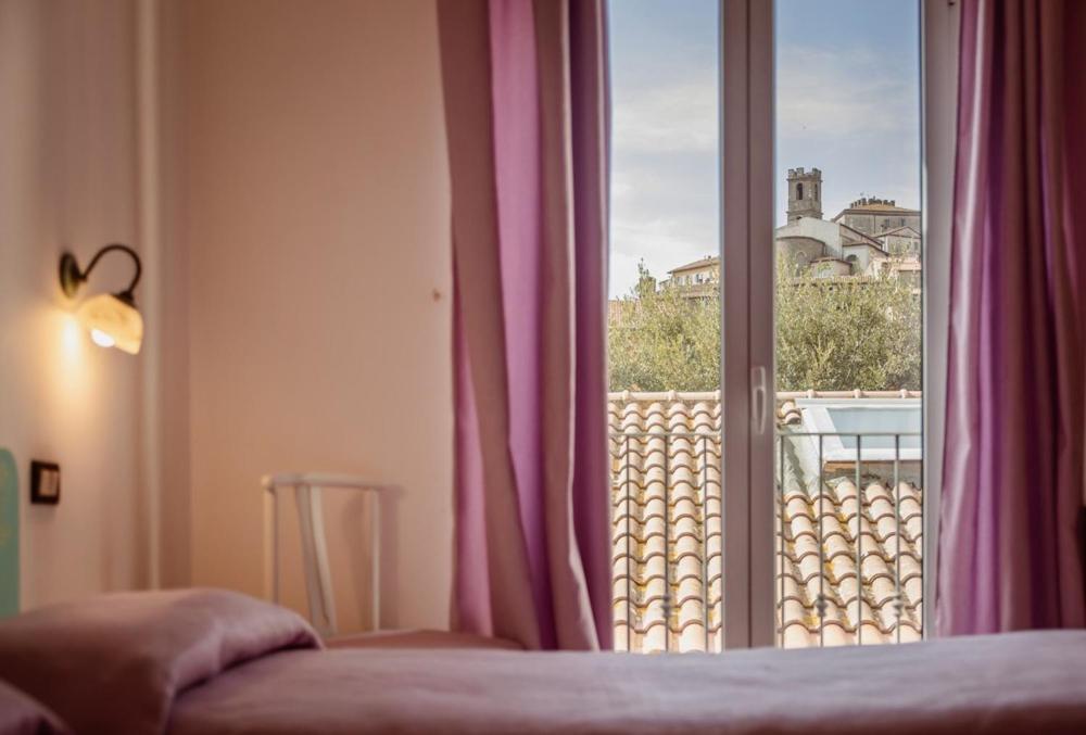 Postel nebo postele na pokoji v ubytování Hotel Rossi