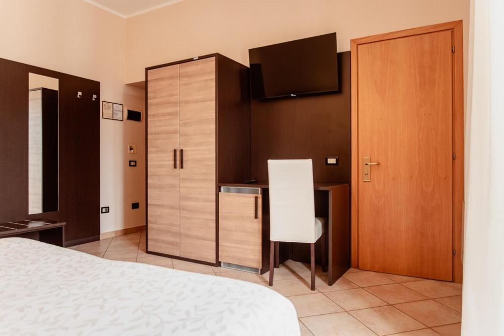 Postel nebo postele na pokoji v ubytování Hotel Rossi