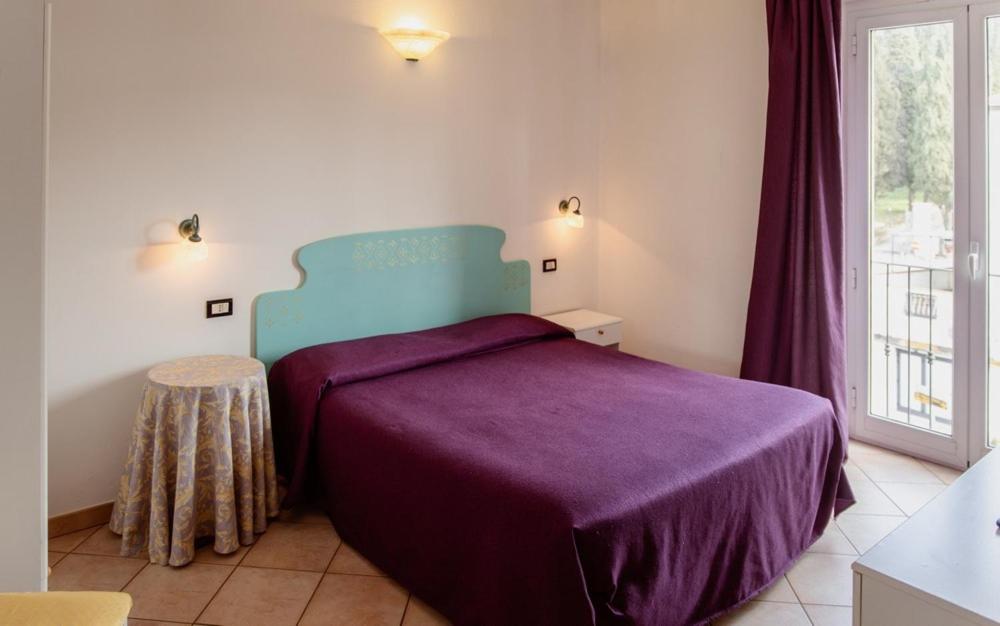 Postel nebo postele na pokoji v ubytování Hotel Rossi