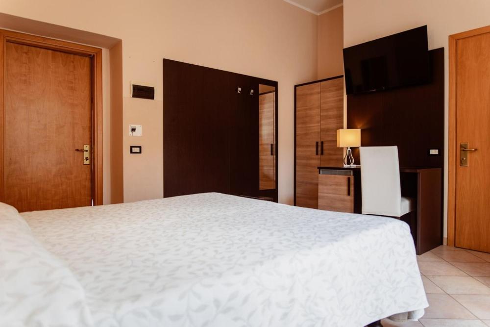 Postel nebo postele na pokoji v ubytování Hotel Rossi