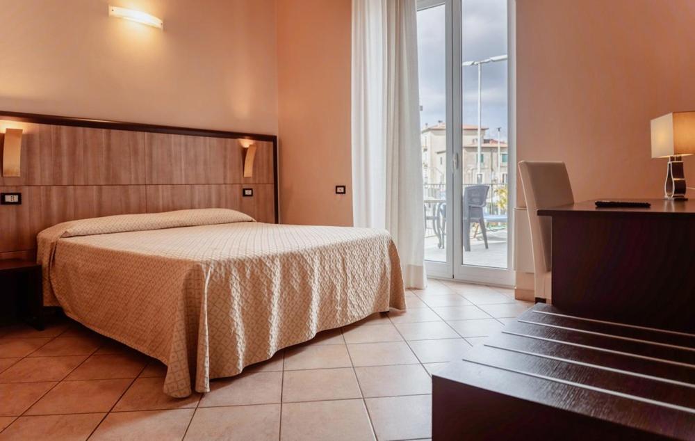 Postel nebo postele na pokoji v ubytování Hotel Rossi