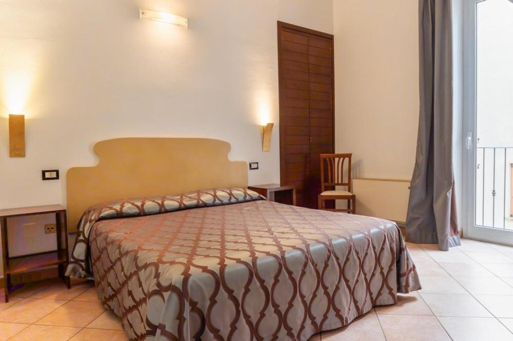 Postel nebo postele na pokoji v ubytování Hotel Rossi