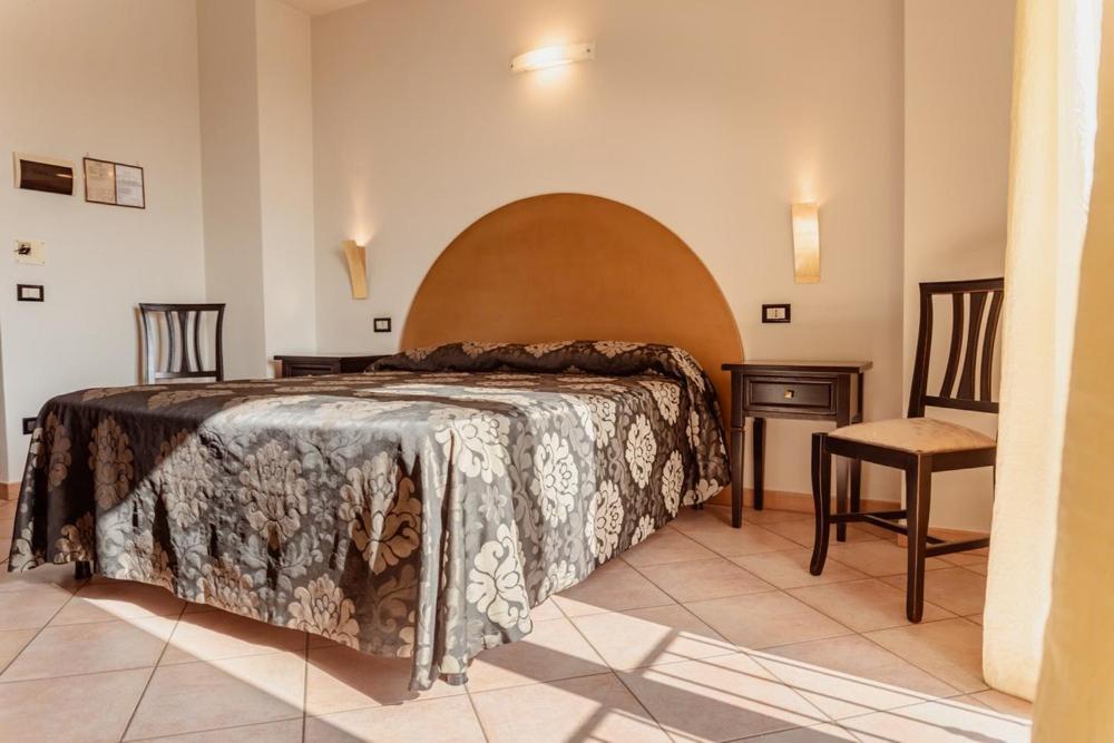 Postel nebo postele na pokoji v ubytování Hotel Rossi