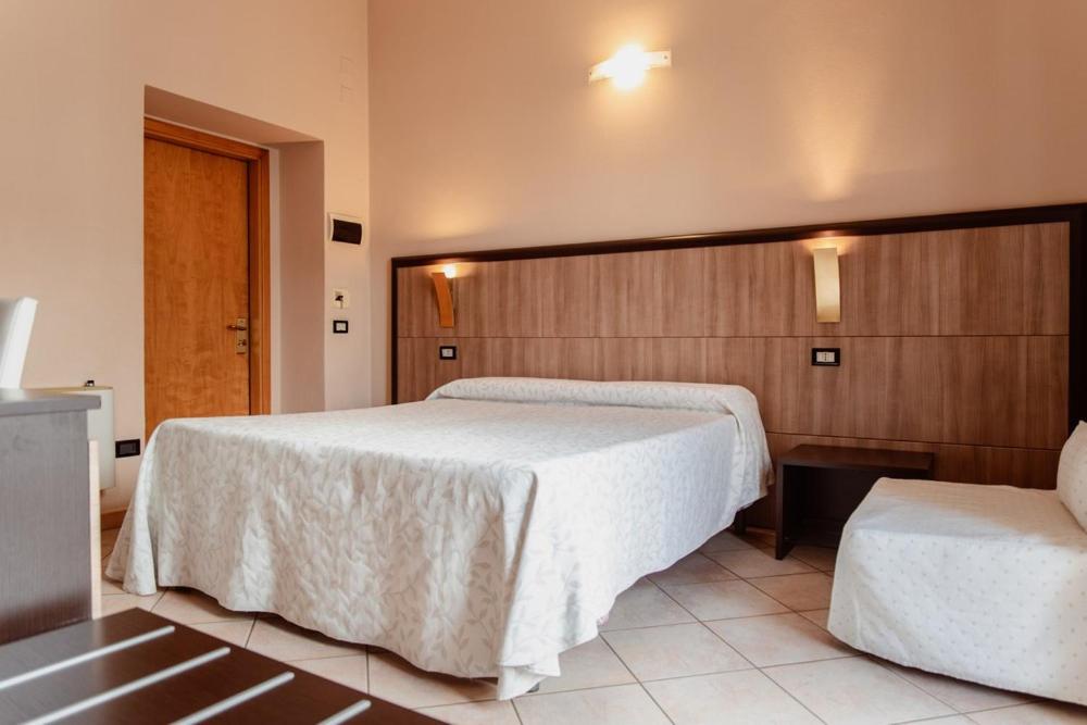 Postel nebo postele na pokoji v ubytování Hotel Rossi