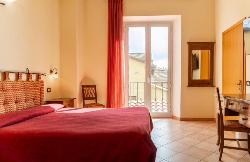 Postel nebo postele na pokoji v ubytování Hotel Rossi