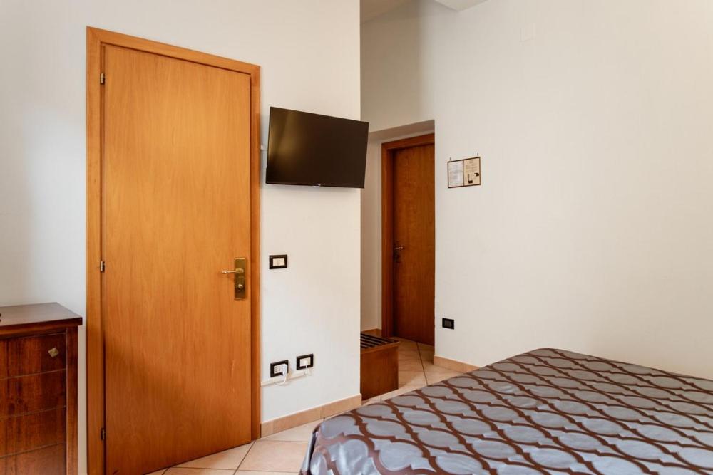 Postel nebo postele na pokoji v ubytování Hotel Rossi