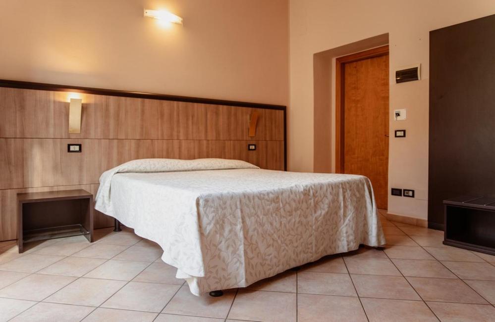 Postel nebo postele na pokoji v ubytování Hotel Rossi