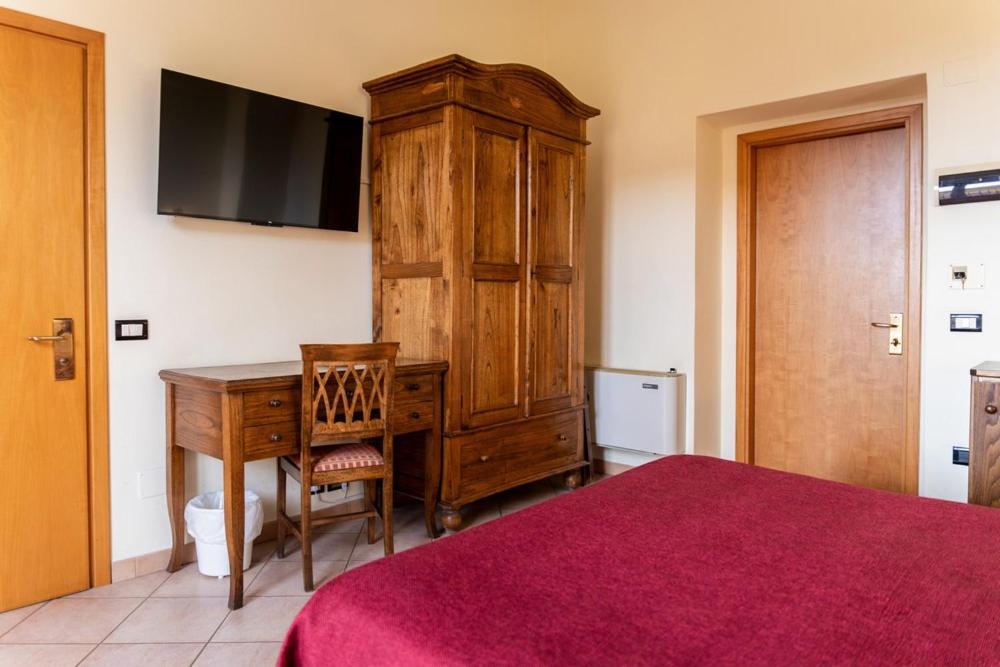 Postel nebo postele na pokoji v ubytování Hotel Rossi