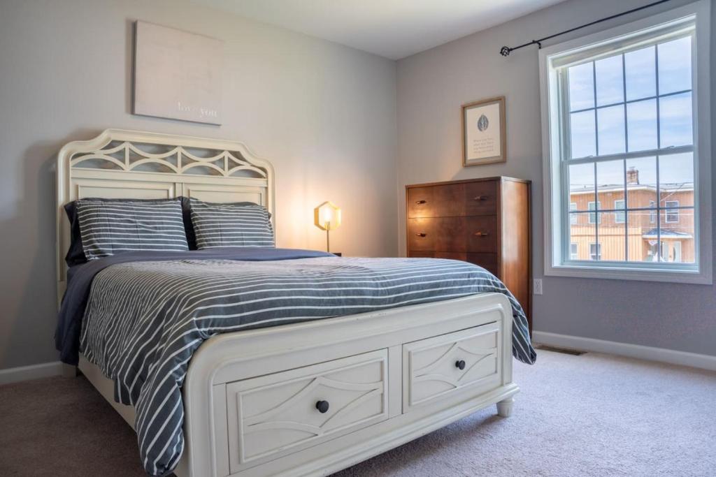 a bedroom with a bed and a window and a dresser at 3 FRESHLY REDONE NEWLY FURNISHED A MUST SEE in Plainville
