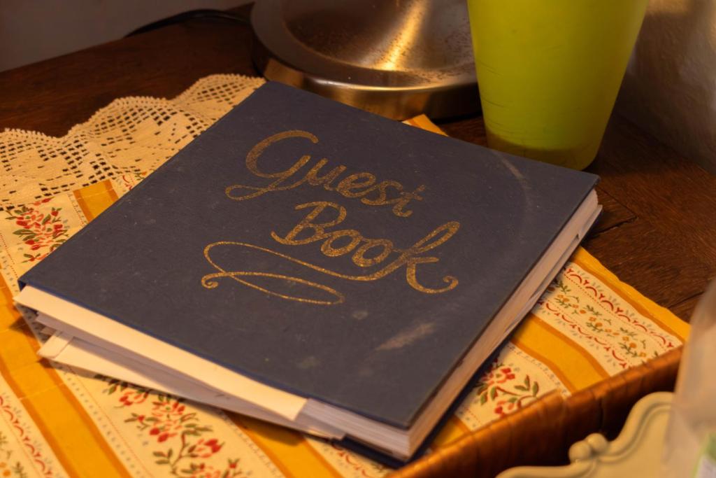 a book with the words guest book sitting on a table at Hostel Argonauta in Óbidos