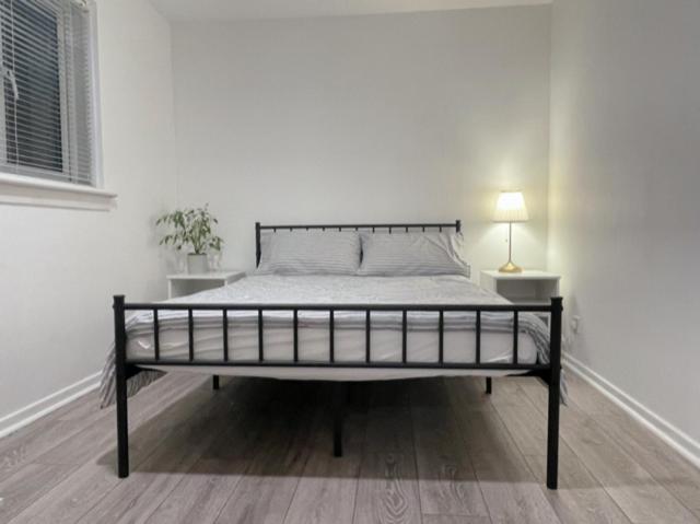 a white bedroom with a bed in a room at Double room in 3 bedroom house in Edinburgh