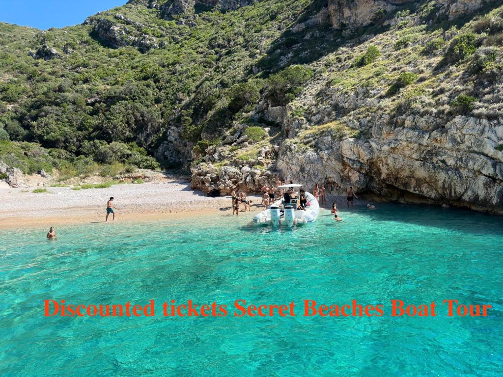 a boat in the water at a beach at SEA SIDE FAMILY APARTMENTs in Vlorë