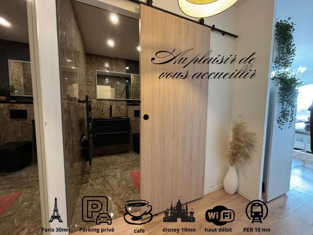 a room with a door with a sign on it at Cocon moderne et cosy proche Disneyland et Paris in Torcy