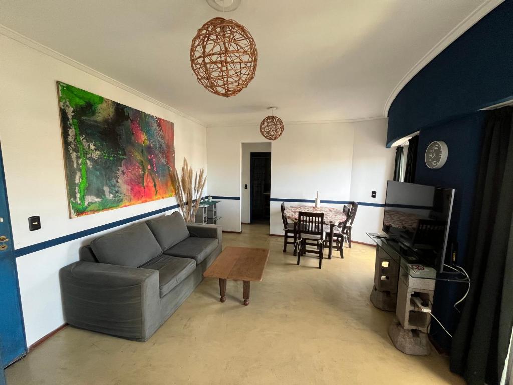 a living room with a couch and a table at Tigre Center Tower F - seguridad 24hs - cochera incluida in Tigre