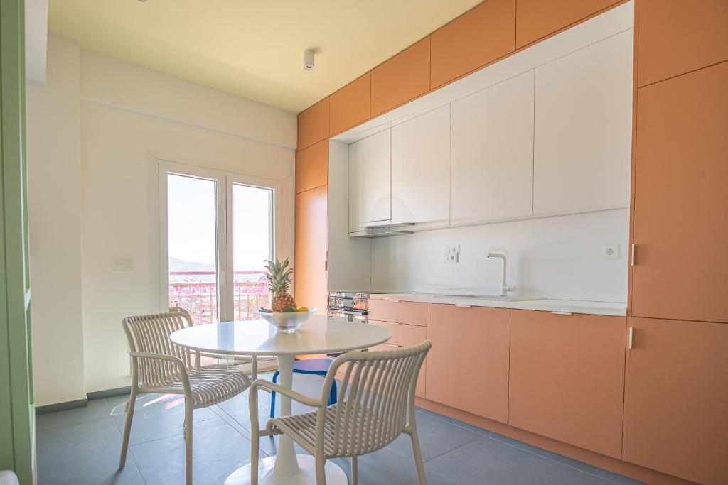 a kitchen with a table and chairs and a window at Alterra Vita Sea View Studio in Neos Marmaras