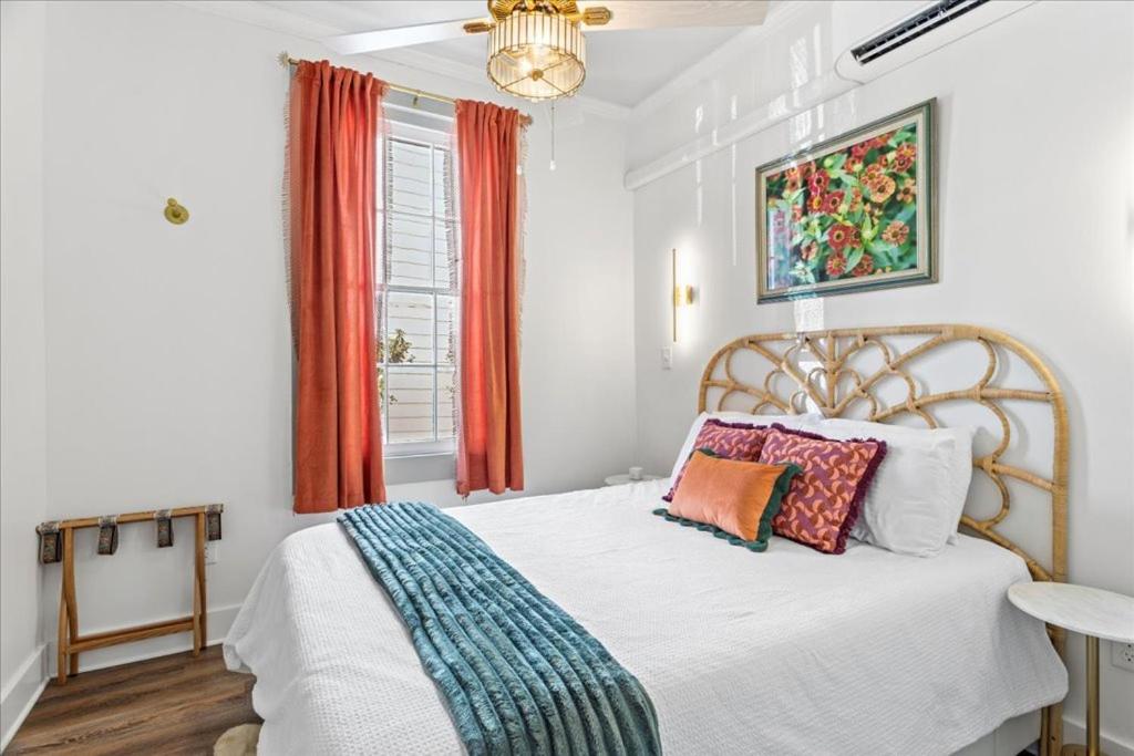 a bedroom with a bed and a window at Old Spanish House Suite A Downtown Retreat in Biloxi