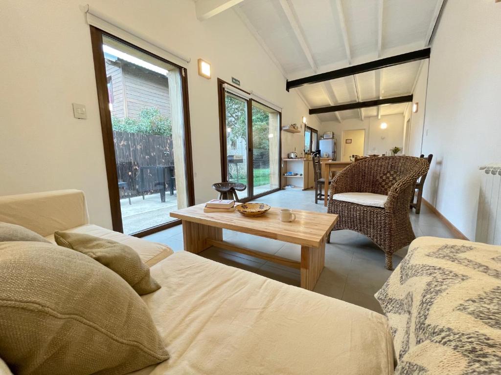a living room with a couch and a table at Los Coirones 2 - Casa con jardin in Dina Huapi