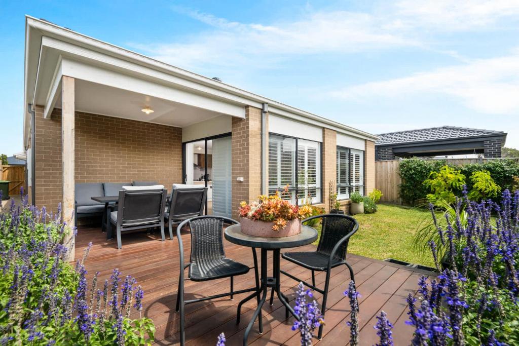 a patio with chairs and a table in a garden at Rowands Residence Mt Duneed in Mount Duneed