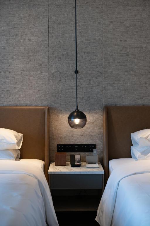 Postel nebo postele na pokoji v ubytování Sheraton Grand Xiamen Jimei