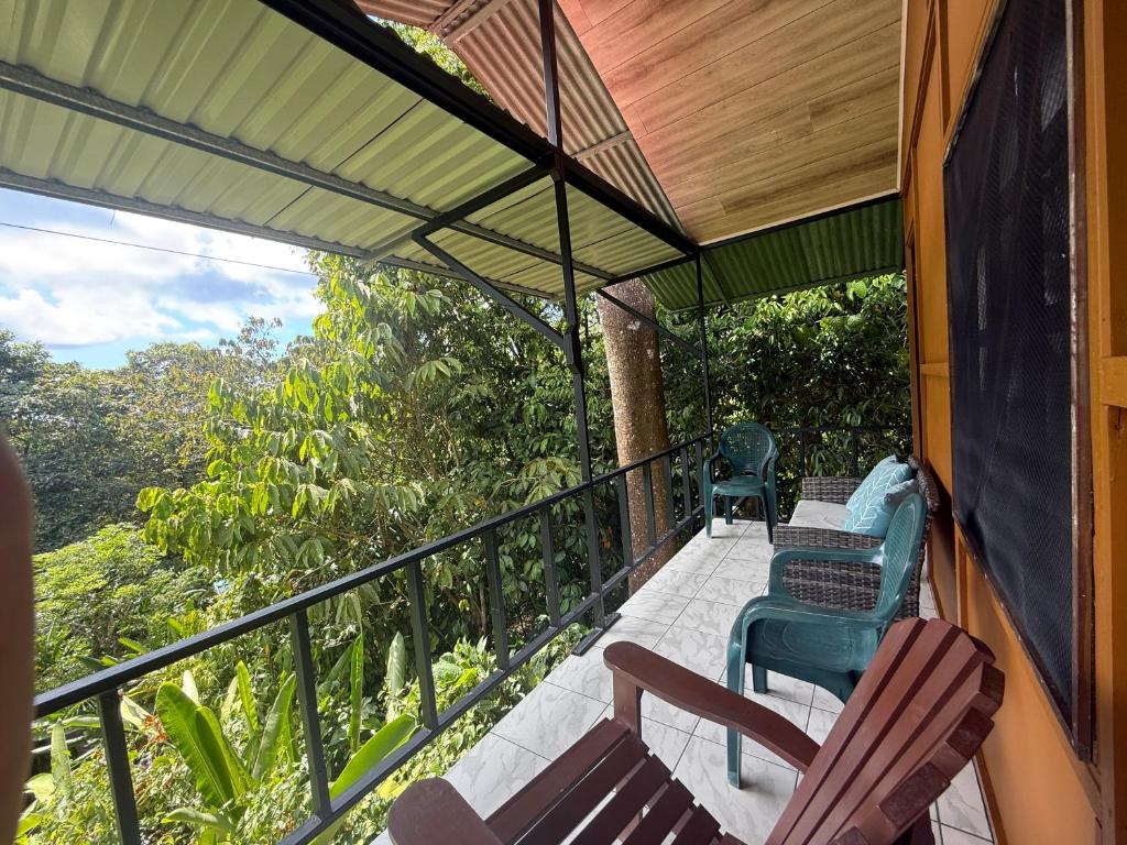 a balcony of a house with chairs and tables at Susan Bungalow #4 in San Pedrillo