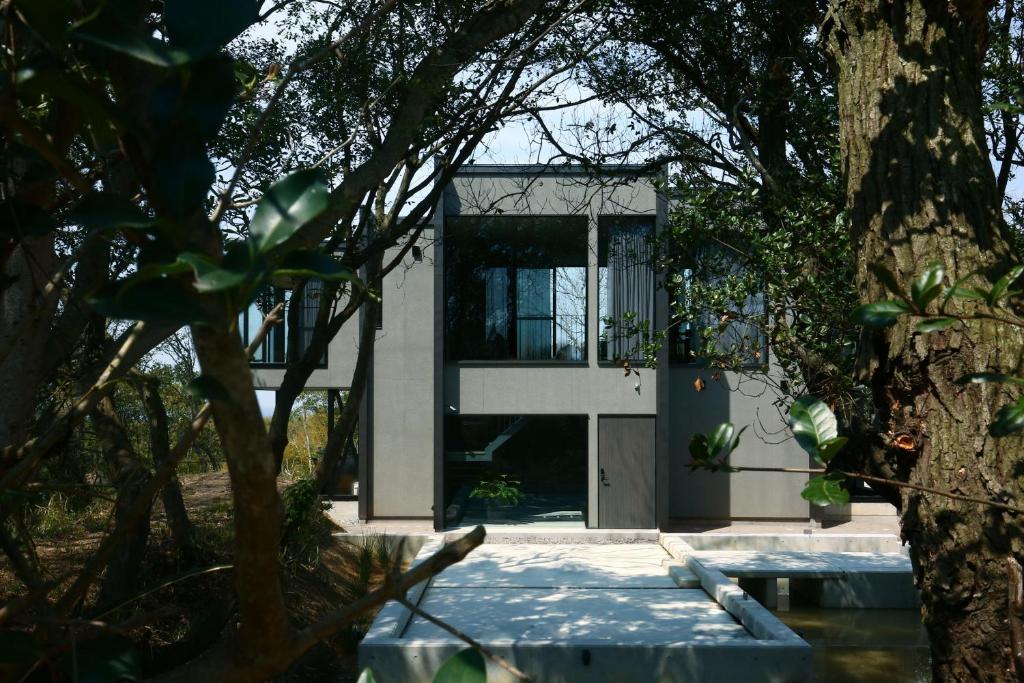 a house with a green door and a tree at KITOW private villa in Awaji