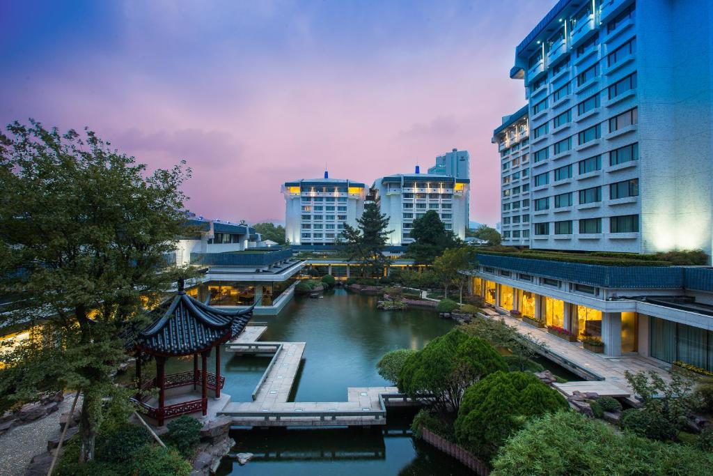 a view of a river in a city with buildings at The Dragon Hotel Hangzhou in Hangzhou