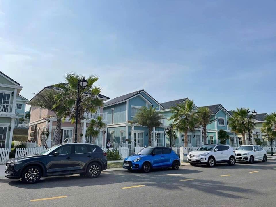 a group of cars parked in a parking lot with houses at Villa Novaworld Phan Thiết 4 Phòng Ngủ Luxury - HT Home in Bình Tú