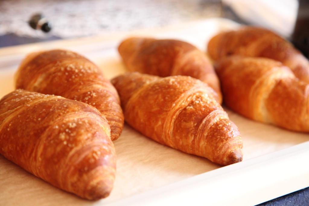 a group of croissants sitting on a cutting board at Albergo Ristorante Papa in Peschiera del Garda