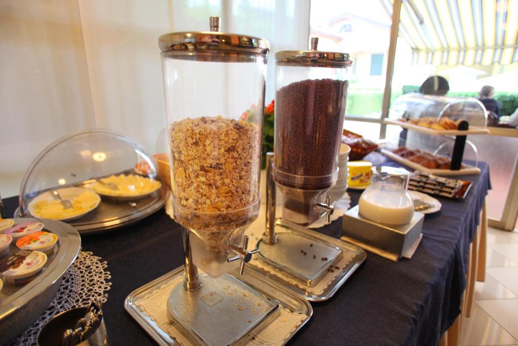 a table with two vases filled with food on it at Albergo Ristorante Papa in Peschiera del Garda