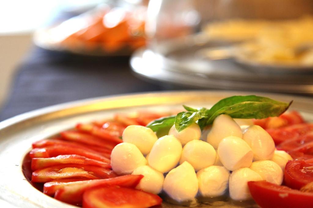 a plate of food with tomatoes and vegetables on a table at Albergo Ristorante Papa in Peschiera del Garda