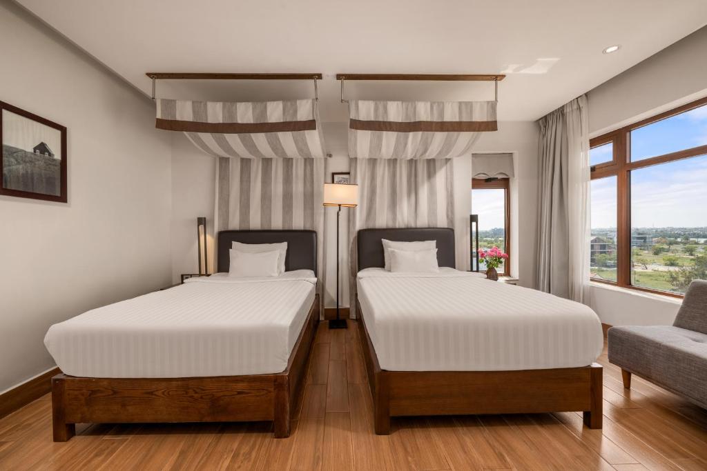 Postel nebo postele na pokoji v ubytování Hoi An Ocean Front Hotel