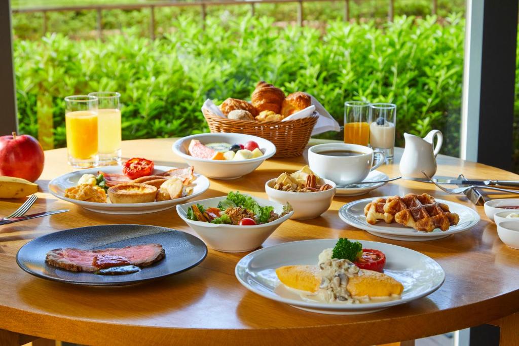 a table with plates of breakfast food on it at Hyatt Regency Tokyo in Tokyo