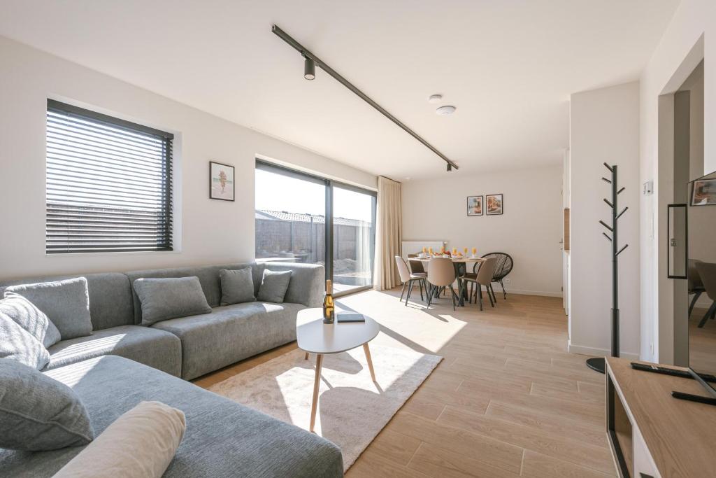 a living room with a couch and a table at Maison Nemo in Nieuwpoort