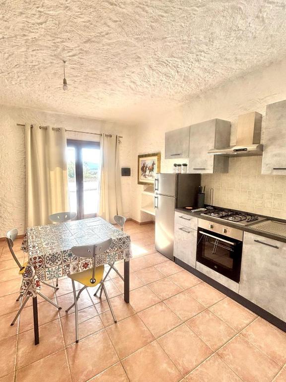 a kitchen with a table and a stove top oven at Nura Bilo 2 in San Teodoro