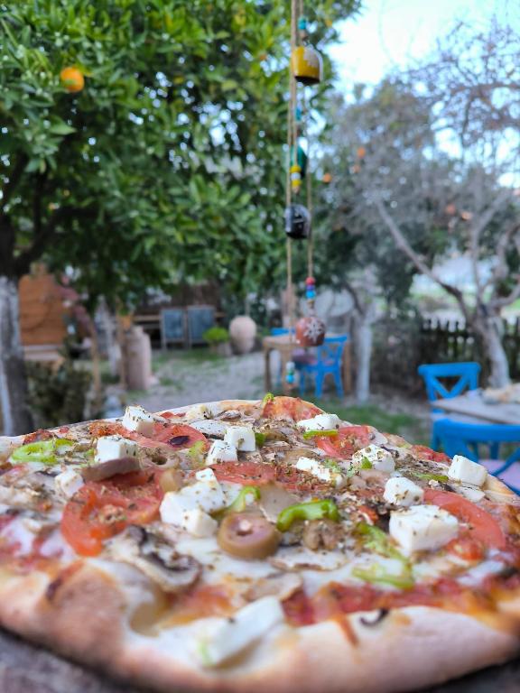 a pizza sitting on top of a table at Litost Cafe in Adrasan