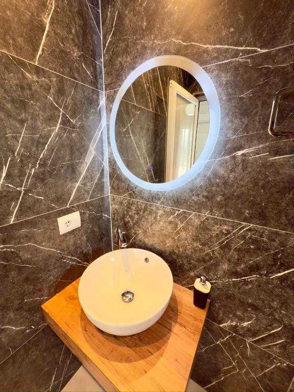 a bathroom with a sink and a mirror at Villa Denis Ksamil in Ksamil