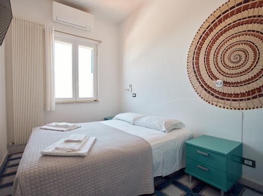 Postel nebo postele na pokoji v ubytování Relais Al Faro Bed&Breakfast